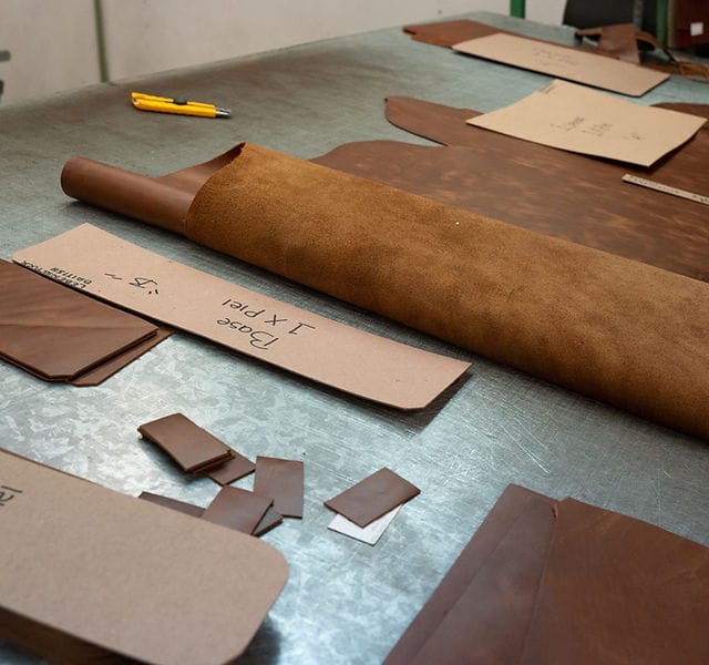 Precision leather stitching in our production house